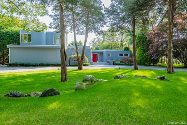 3 Mallard Lane Remsenburg, NY 11960 - Photo 2 of 40 a view of a backyard with a small house and a tree