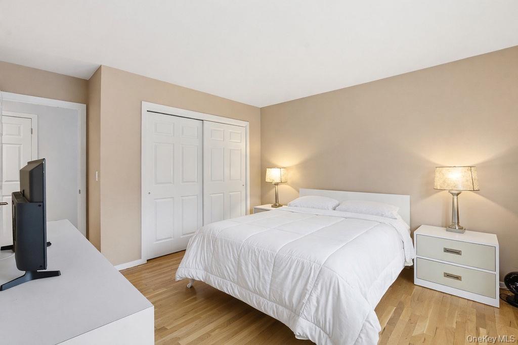 3 Mallard Lane Remsenburg, NY 11960 - Photo 22 of 40 a bedroom with a bed and a flat screen tv