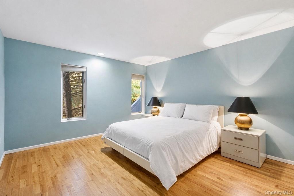 3 Mallard Lane Remsenburg, NY 11960 - Photo 23 of 40 a bedroom with a bed and a lamp on dresser