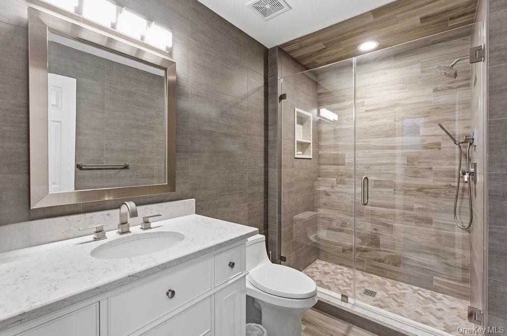 3 Mallard Lane Remsenburg, NY 11960 - Photo 24 of 40 a bathroom with a sink shower and a toilet
