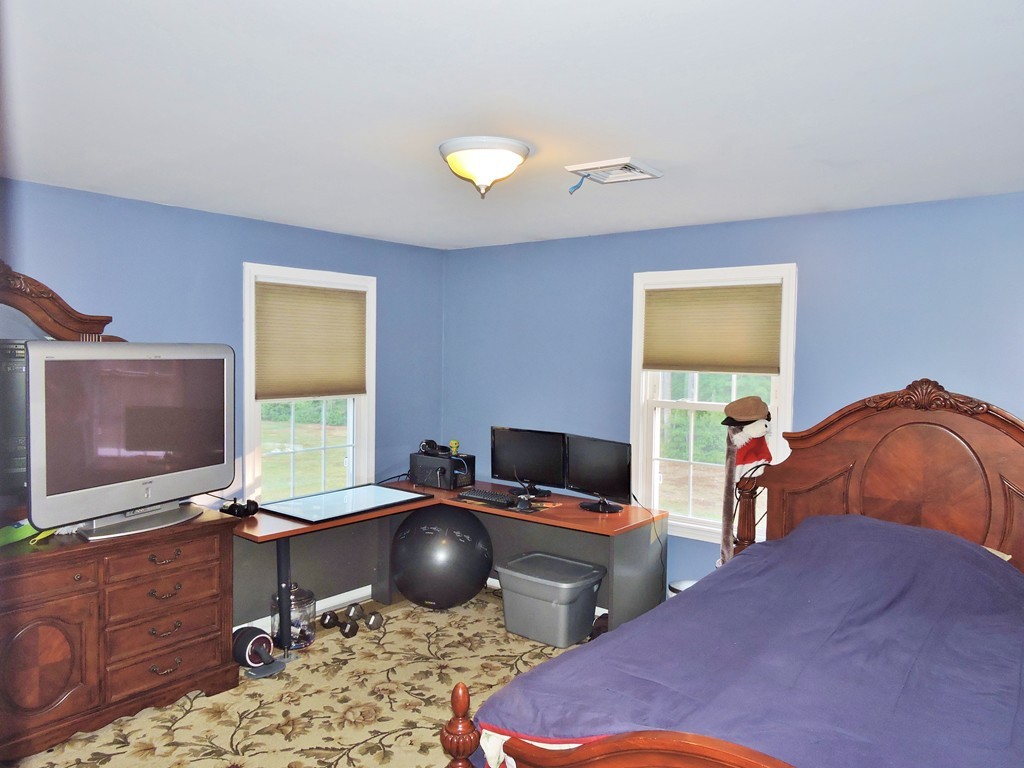 3 Cromwell Lane Rochester, MA 02770 - Photo 13 of 15 a bedroom with a bed and a flat screen tv