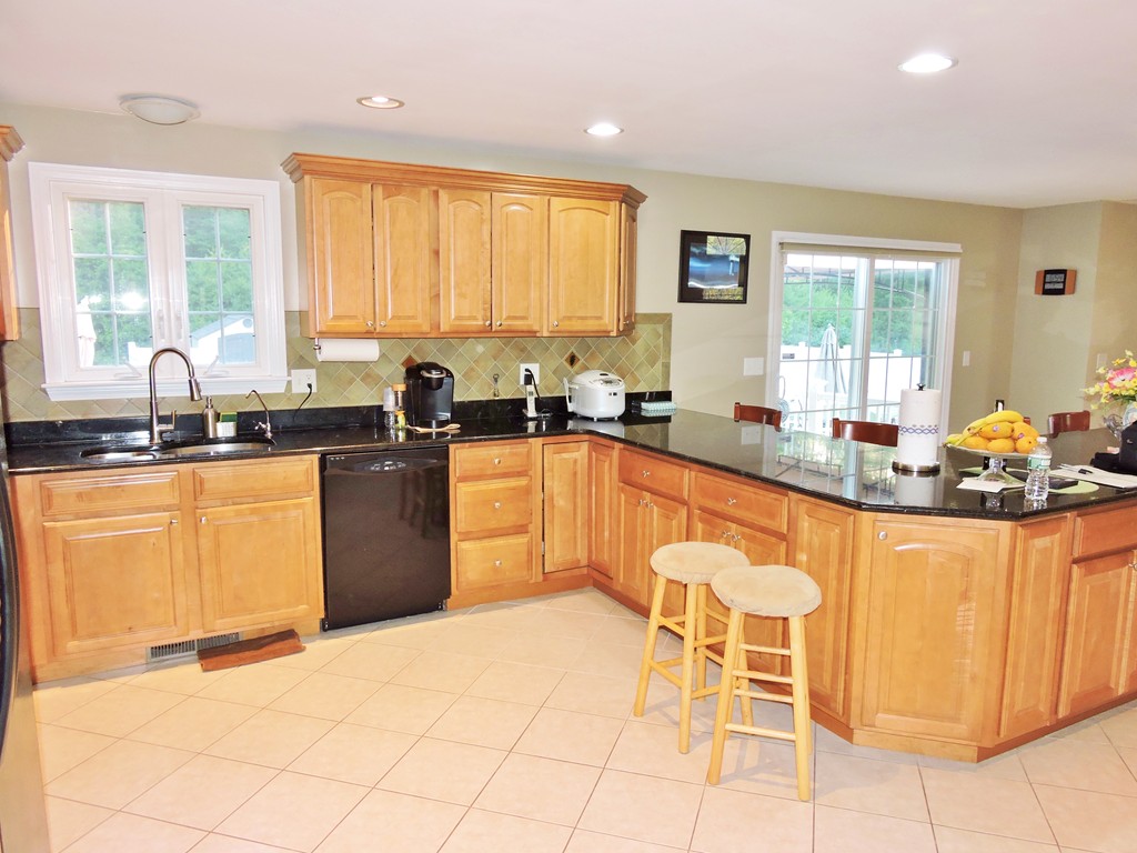 3 Cromwell Lane Rochester, MA 02770 - Photo 7 of 15 a kitchen with stainless steel appliances granite countertop a stove a sink a counter space and dining table