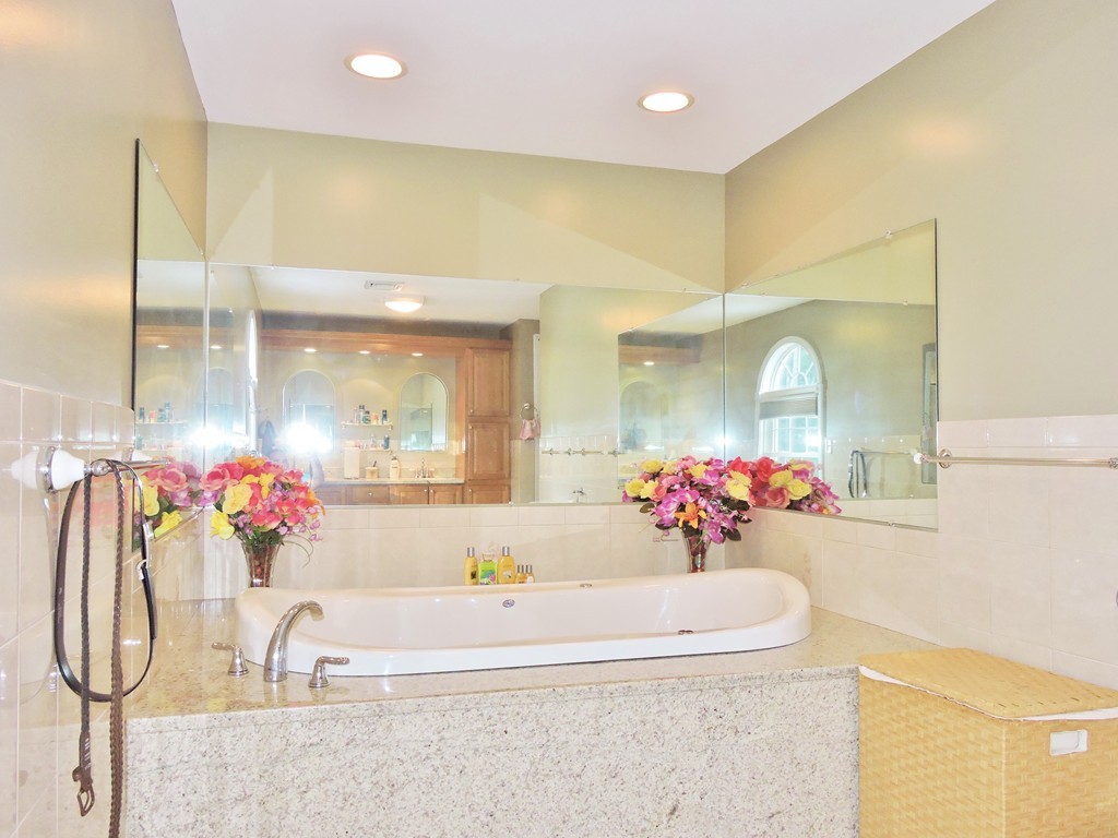 3 Cromwell Lane Rochester, MA 02770 - Photo 9 of 15 a bathroom with a bathtub sink and mirror