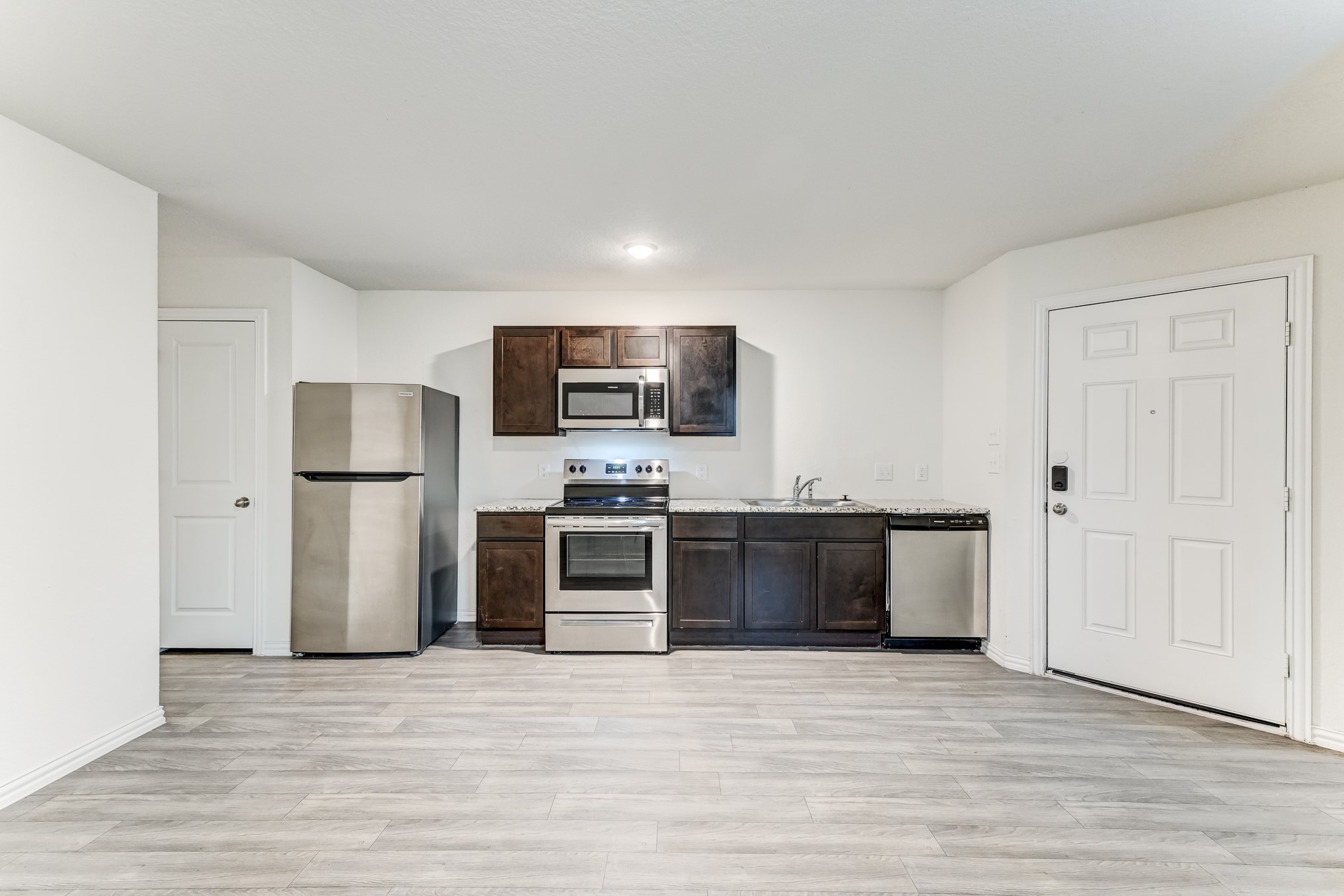 7925 Way Street Houston, TX 77028 - Photo 9 of 29 a kitchen with stainless steel appliances granite countertop a refrigerator and a stove top oven