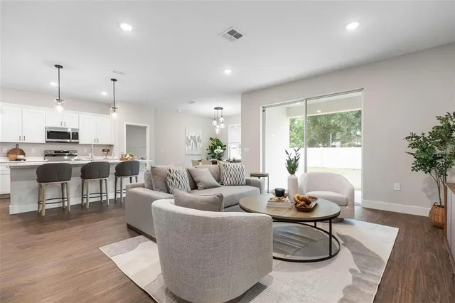 a living room with furniture and a potted plant