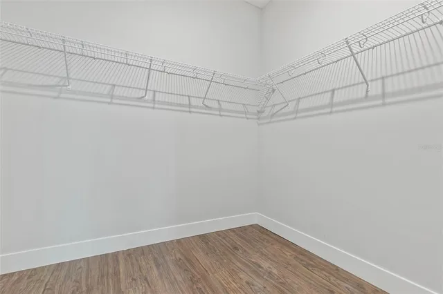 a spacious bathroom with a granite countertop sink and a mirror