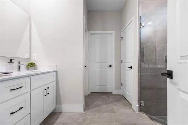 a bathroom with a double vanity sink and mirror