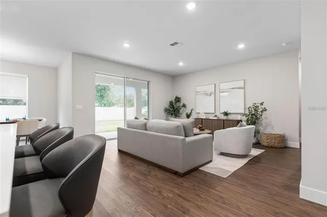 a living room with furniture kitchen and a table