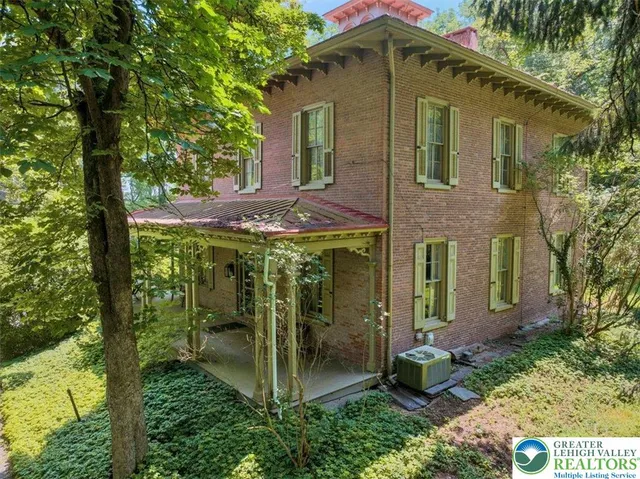 a view of a house with a yard and sitting area