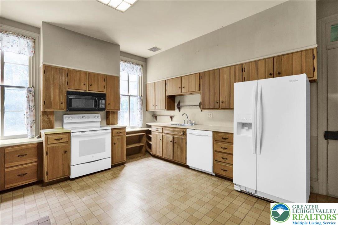 1670 Moselem Spring Road Hamburg, PA 19526 - Photo 35 of 50 a kitchen with white cabinets and white appliances
