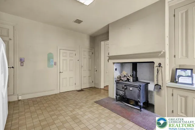 a view of empty room with window and fireplace