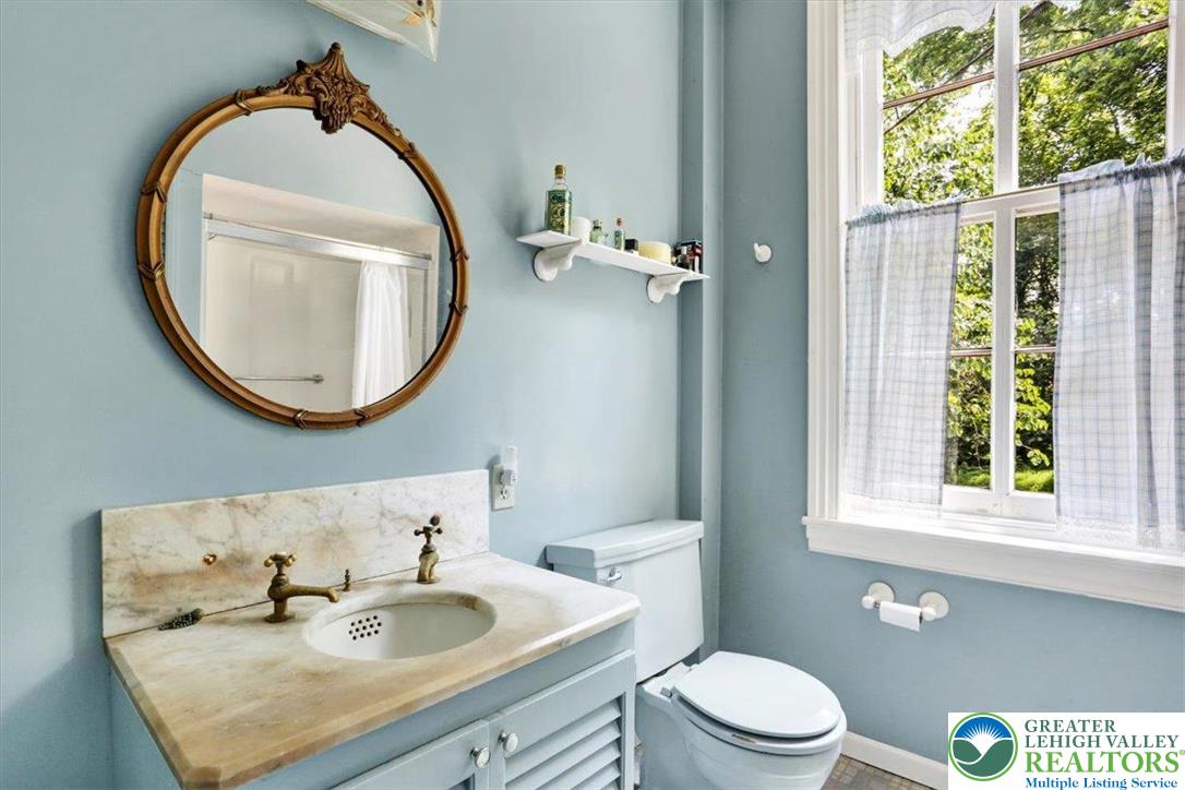 1670 Moselem Spring Road Hamburg, PA 19526 - Photo 37 of 50 a bathroom with a sink a toilet and a mirror