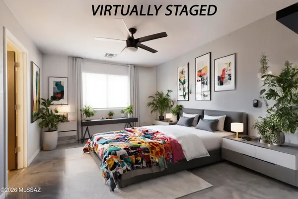 a bedroom with a large bed and a chandelier