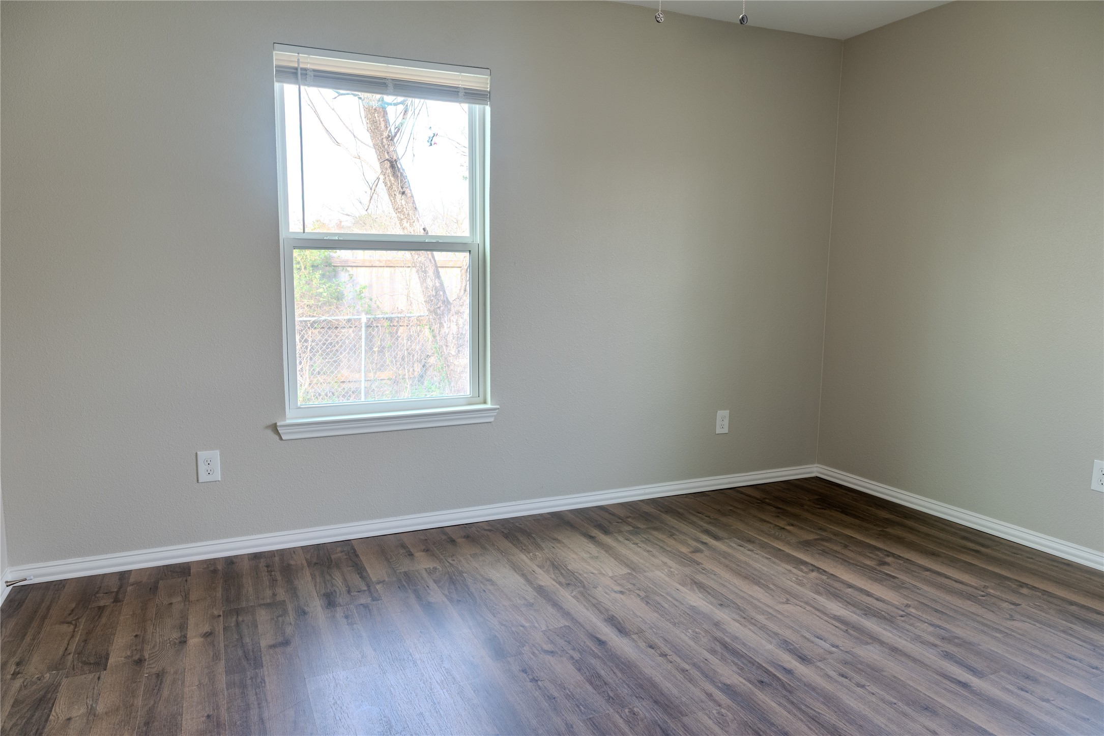 729 Planters Street Emory, TX 75440 - Photo 17 of 22 an empty room with wooden floor and windows