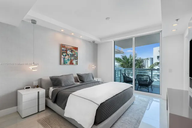 a bedroom with a large bed and a large window