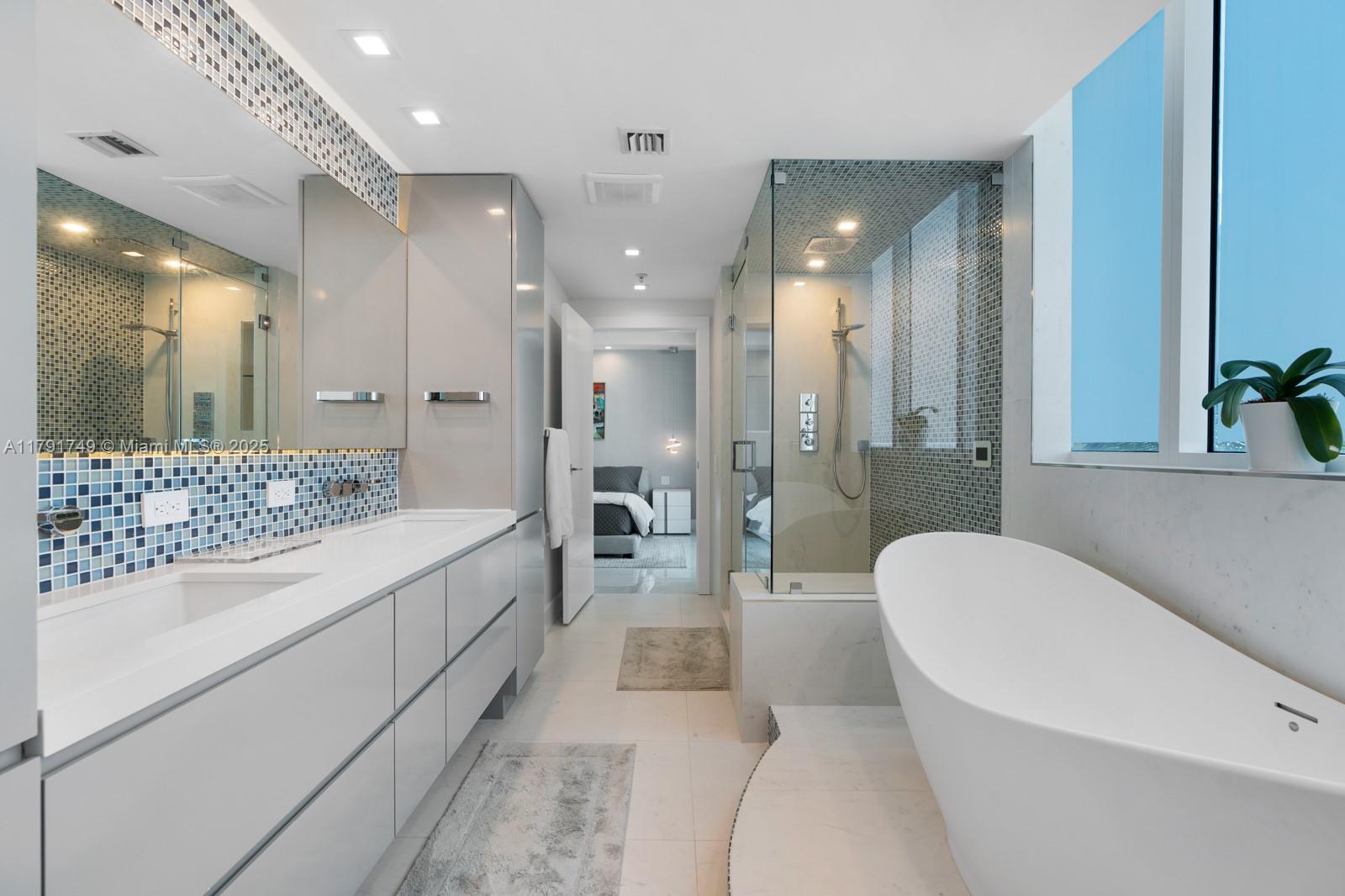 3801 Collins Avenue, Unit 703 Miami Beach, FL 33140 - Photo 12 of 20 a spacious bathroom with a bathtub shower sink and toilet