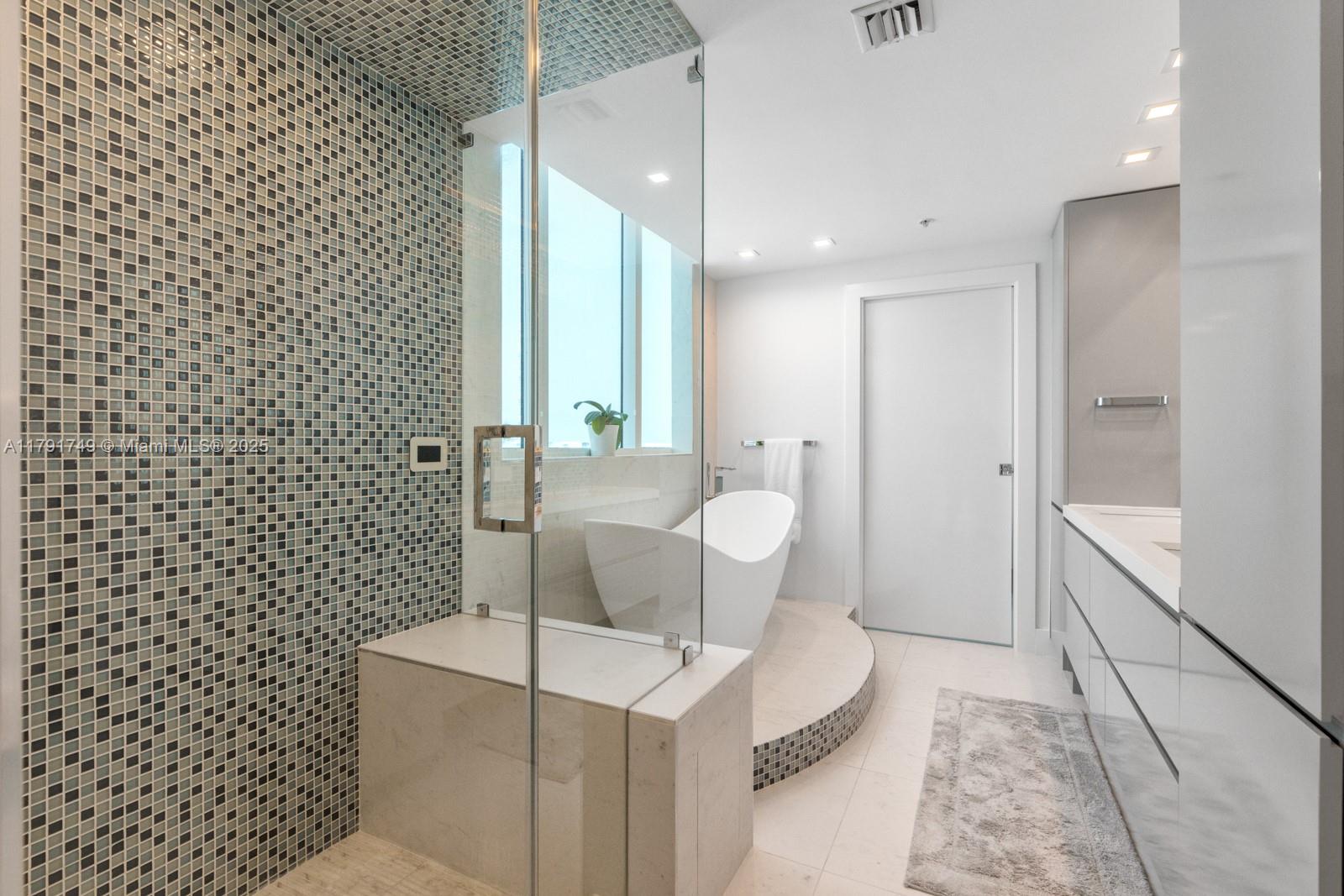 3801 Collins Avenue, Unit 703 Miami Beach, FL 33140 - Photo 13 of 20 a bathroom with a sink toilet and shower