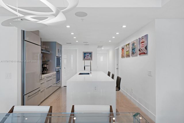 a view of kitchen with furniture and stainless steel appliances