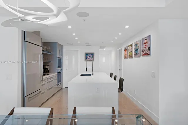 a view of kitchen with furniture and stainless steel appliances