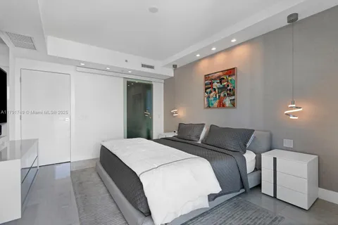 a bedroom with a bed and a couch