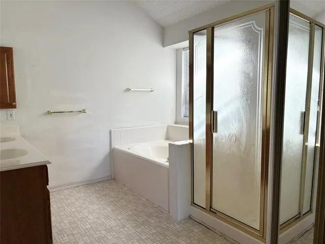 a bathroom with a bathtub and shower