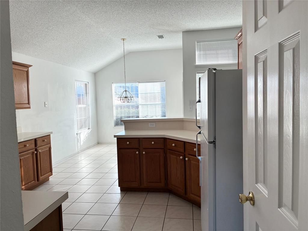 1002 Morningside Lane Allen, TX 75002 - Photo 12 of 18 a kitchen with stainless steel appliances granite countertop a refrigerator and a sink