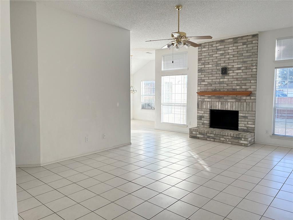 1002 Morningside Lane Allen, TX 75002 - Photo 2 of 18 an empty room with windows and fireplace