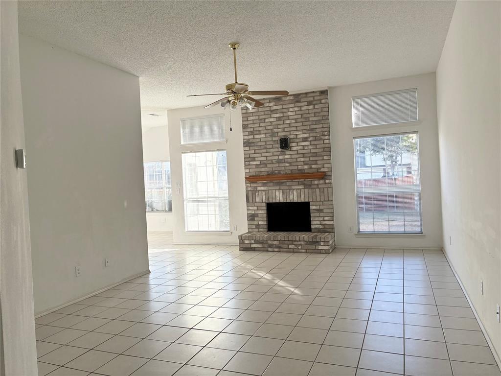1002 Morningside Lane Allen, TX 75002 - Photo 4 of 18 a view of empty room with wooden floor and fireplace