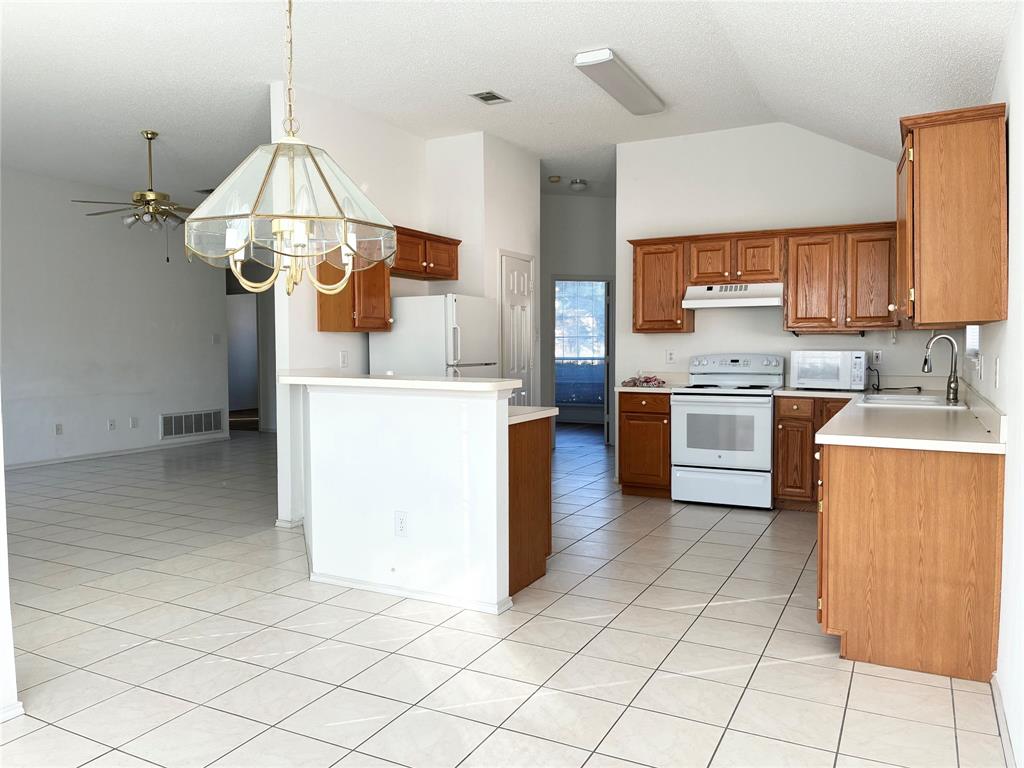 1002 Morningside Lane Allen, TX 75002 - Photo 5 of 18 a kitchen with stainless steel appliances a stove a sink and white cabinets