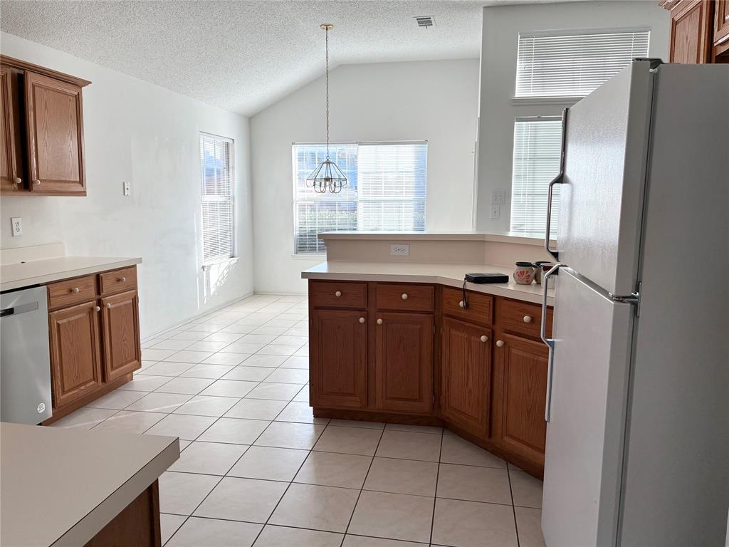 1002 Morningside Lane Allen, TX 75002 - Photo 6 of 18 a kitchen with stainless steel appliances granite countertop a refrigerator and a sink