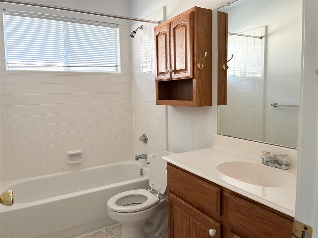 1002 Morningside Lane Allen, TX 75002 - Photo 7 of 18 a bathroom with a sink a toilet and shower
