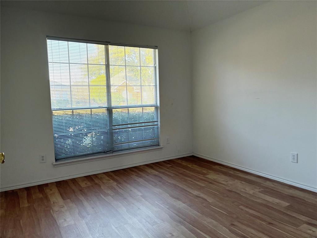 1002 Morningside Lane Allen, TX 75002 - Photo 10 of 18 an empty room with wooden floor and windows