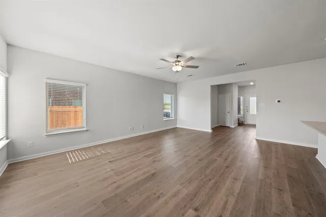 a kitchen with stainless steel appliances granite countertop a sink a microwave a refrigerator and a stove