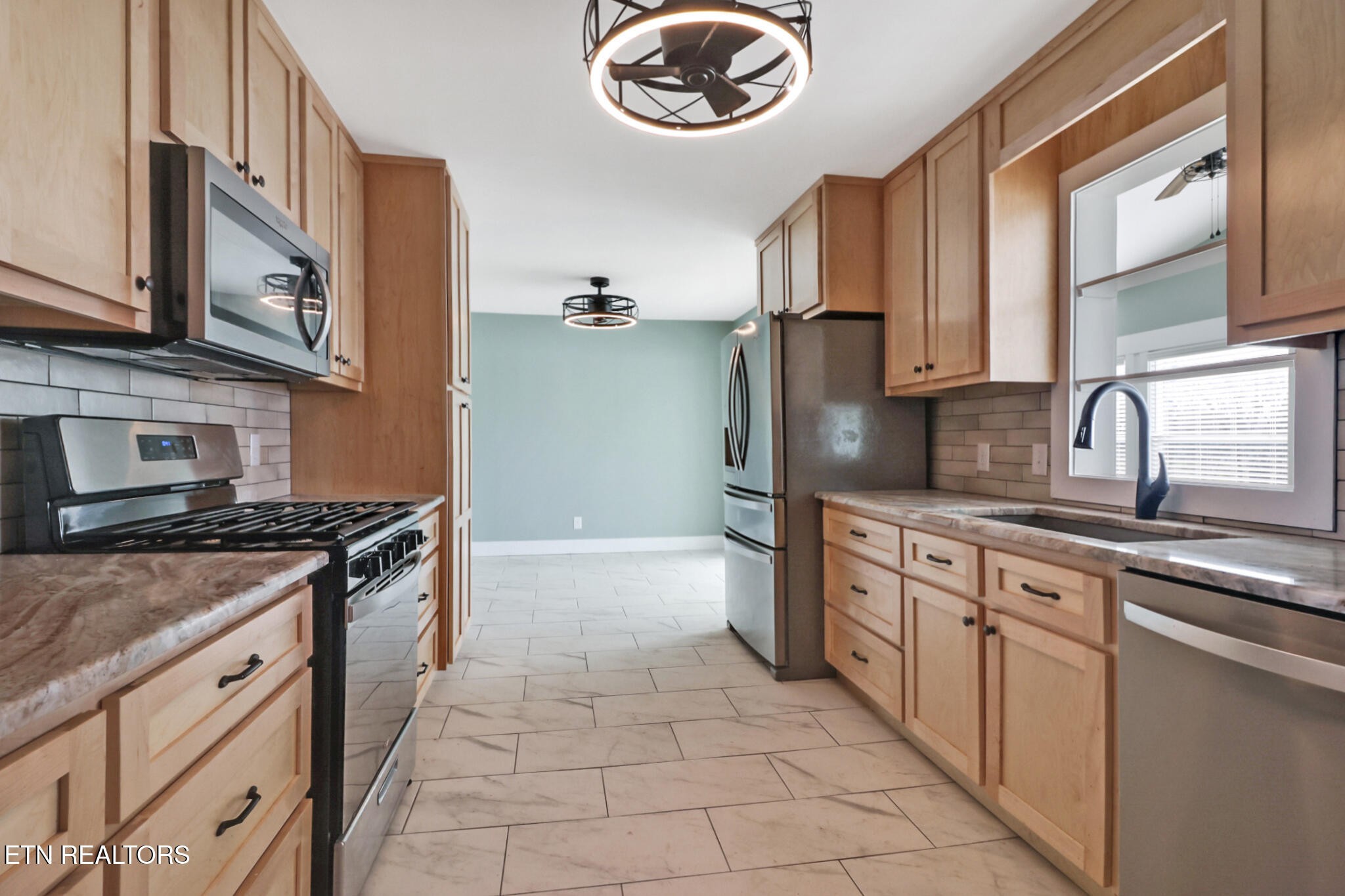 1065 Old Grimsley Road Grimsley, TN 38565 - Photo 14 of 43 a kitchen with stainless steel appliances granite countertop a stove a sink and a microwave