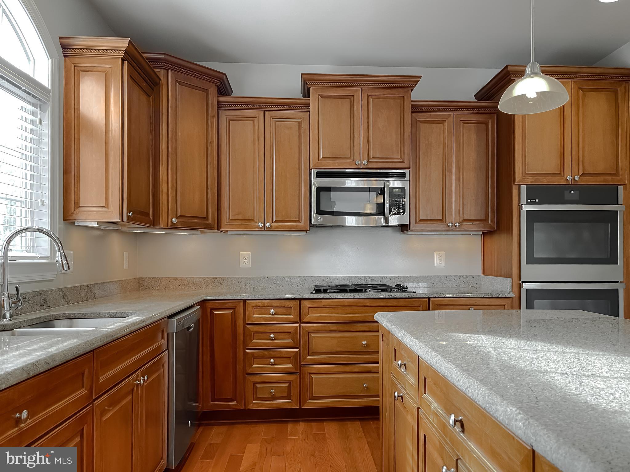 43361 Quail Street Hollywood, MD 20636 - Photo 14 of 73 a kitchen with stainless steel appliances granite countertop a sink stove and microwave
