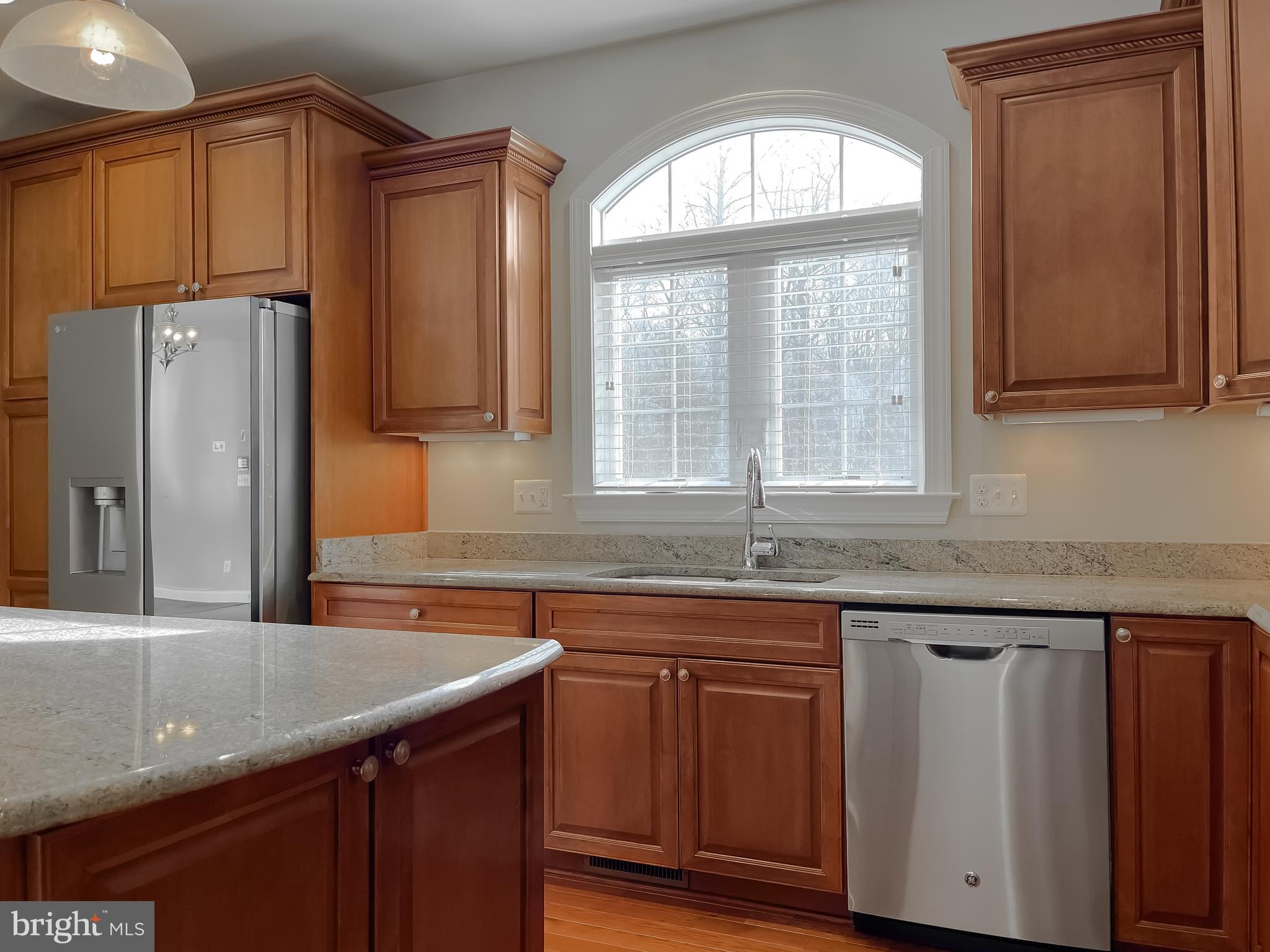 43361 Quail Street Hollywood, MD 20636 - Photo 15 of 73 a kitchen with granite countertop a sink and a refrigerator