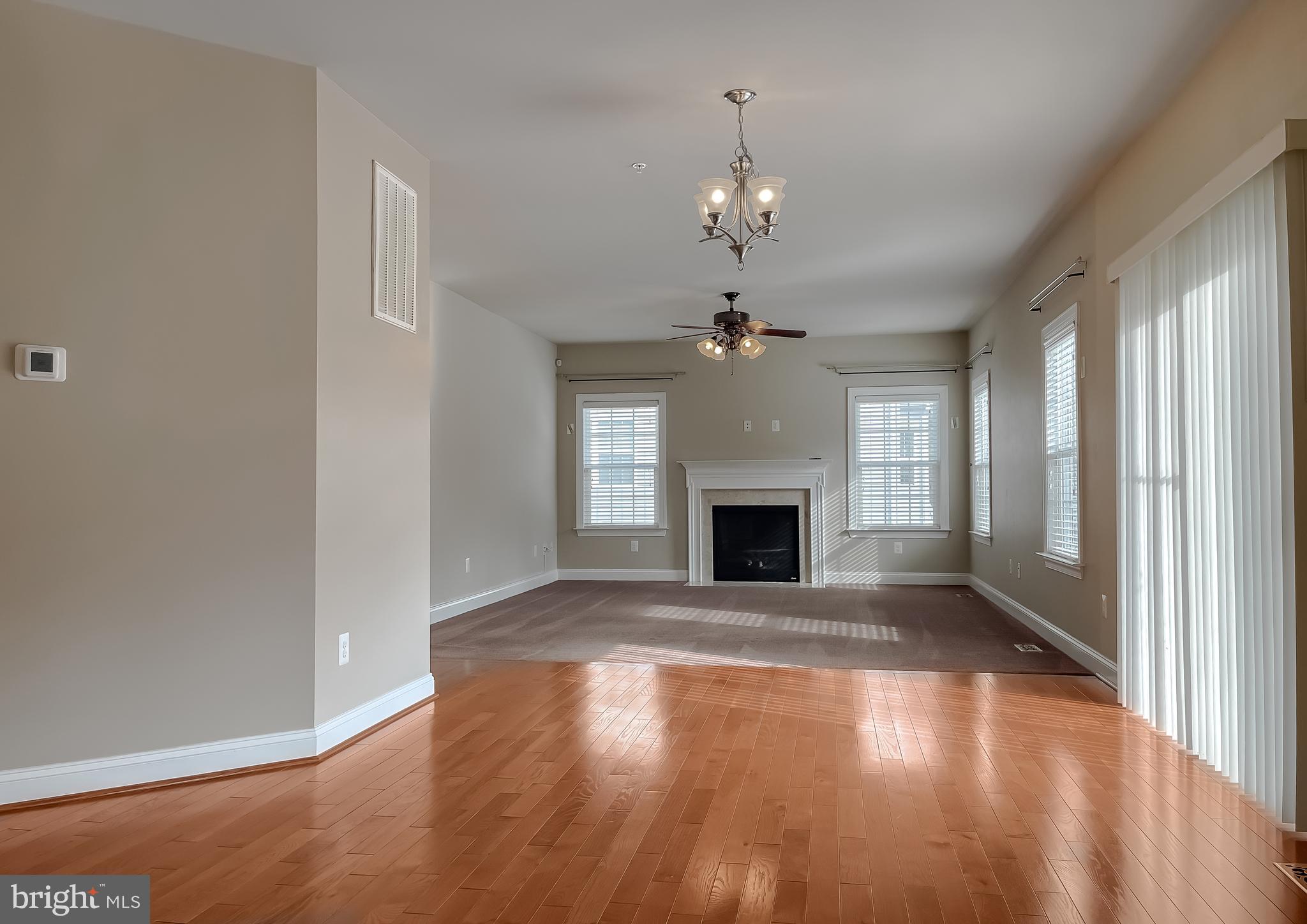 43361 Quail Street Hollywood, MD 20636 - Photo 16 of 73 a view of an empty room with wooden floor fireplace and a window
