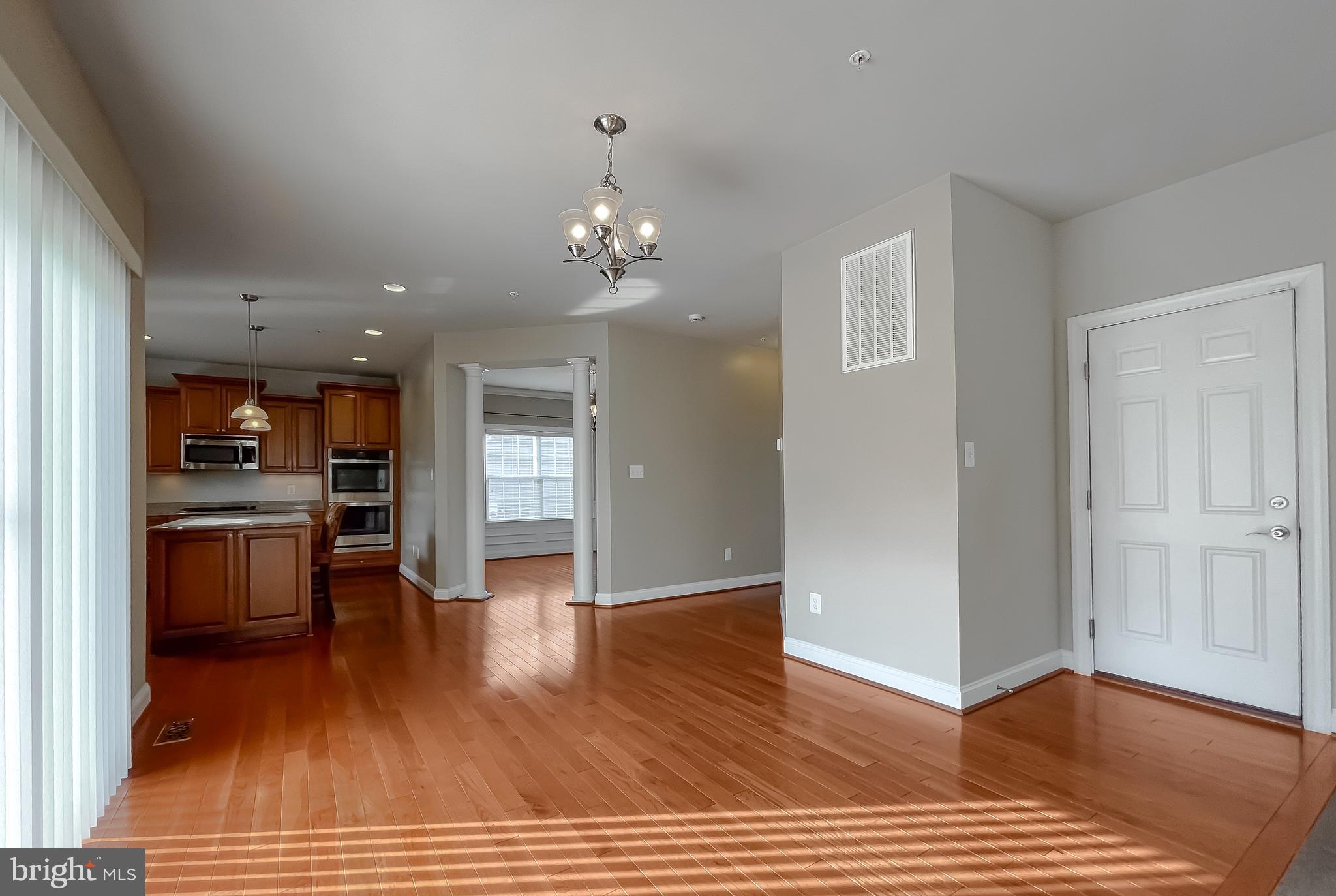43361 Quail Street Hollywood, MD 20636 - Photo 23 of 73 a view of a hallway with wooden floor and a kitchen