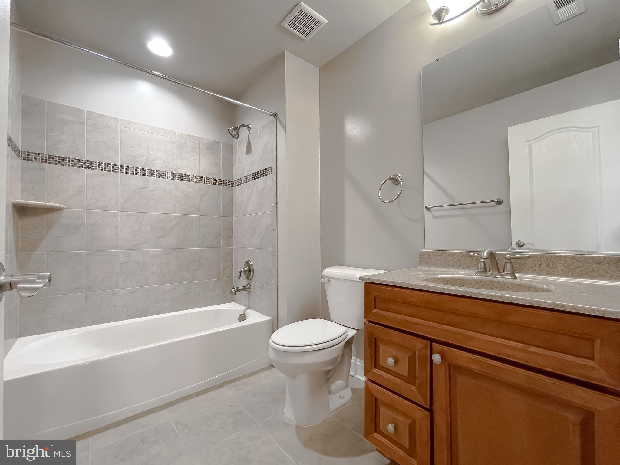 43361 Quail Street Hollywood, MD 20636 - Photo 35 of 73 a bathroom with a granite countertop sink a toilet and shower