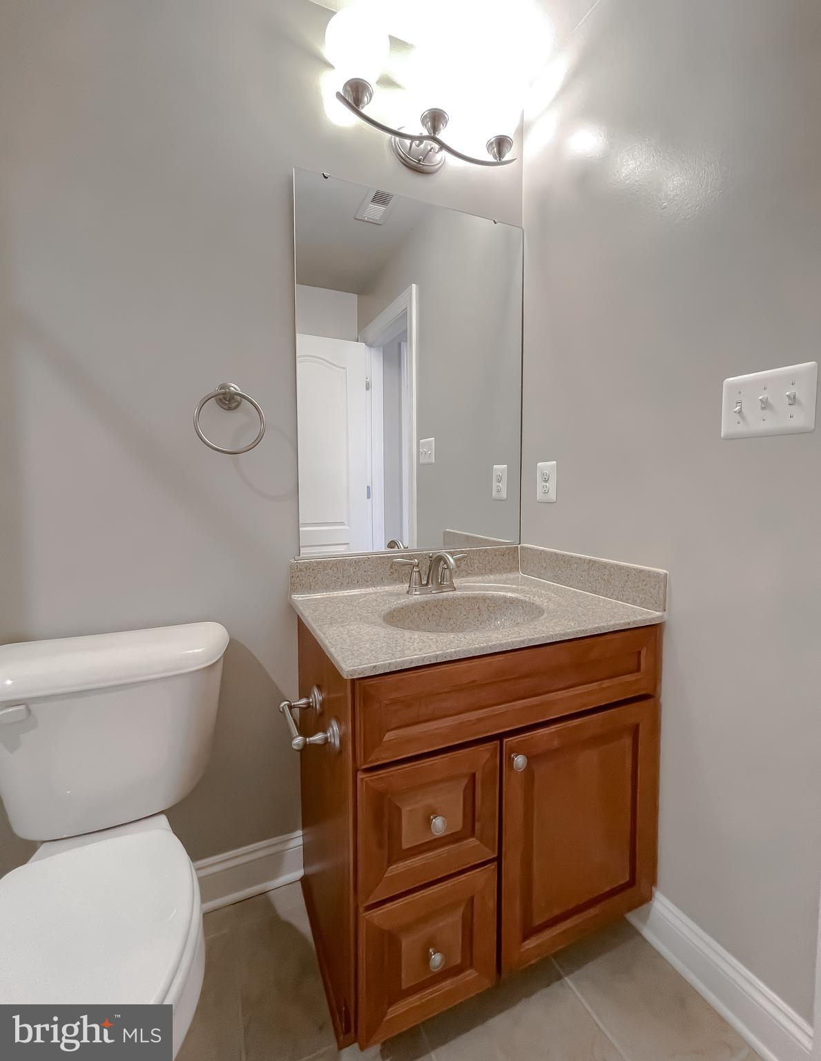 43361 Quail Street Hollywood, MD 20636 - Photo 37 of 73 a bathroom with a granite countertop toilet sink and mirror
