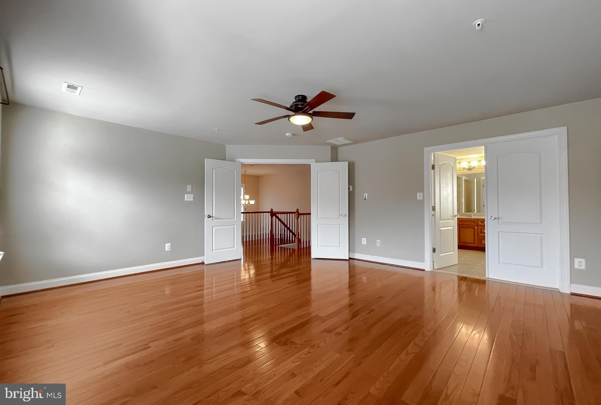 43361 Quail Street Hollywood, MD 20636 - Photo 40 of 73 a view of an empty room with wooden floor and a ceiling fan