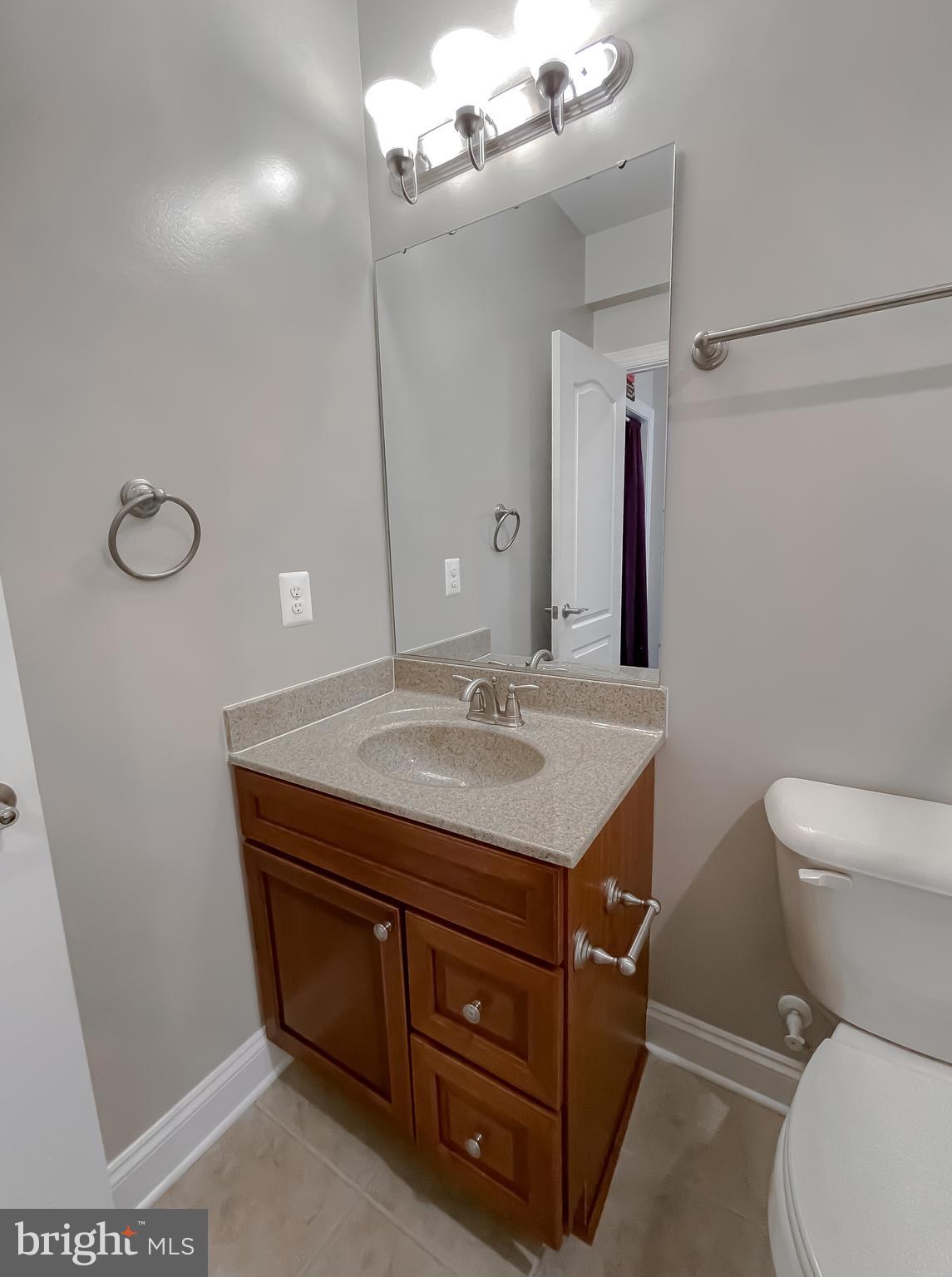 43361 Quail Street Hollywood, MD 20636 - Photo 53 of 73 a bathroom with a granite countertop sink a toilet and a mirror