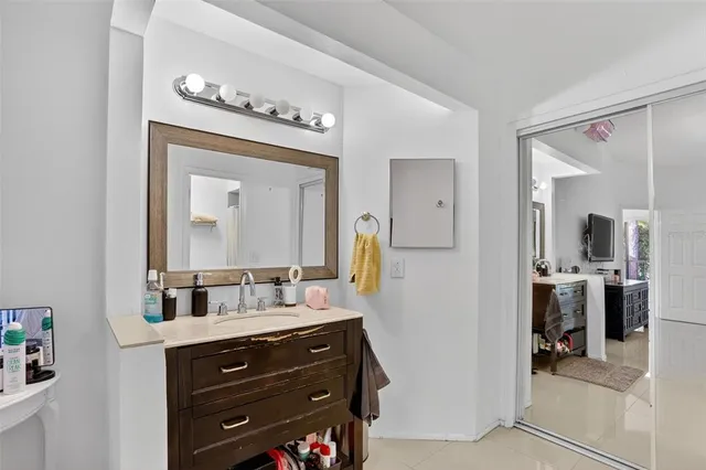 a bathroom with a sink vanity and a mirror