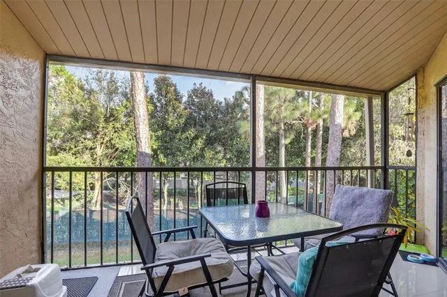 a view of a city from a dining room with furniture and window