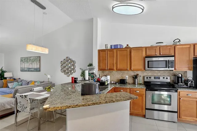 a kitchen with stainless steel appliances granite countertop a sink dishwasher stove and cabinets