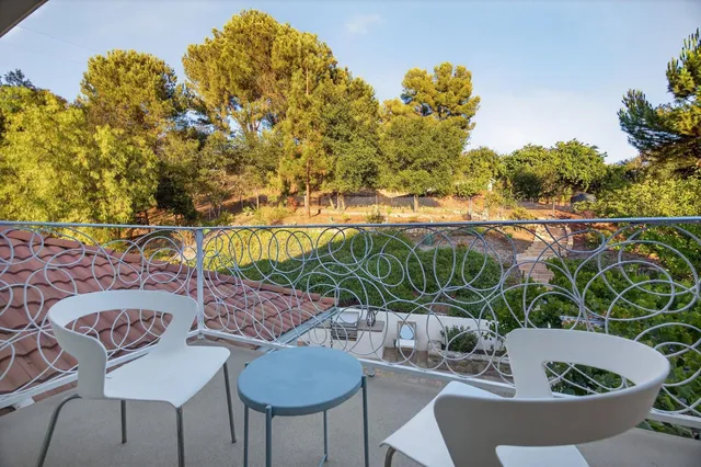 a view of a house with swimming pool and sitting area
