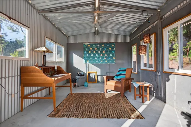 a room with furniture and a floor to ceiling window