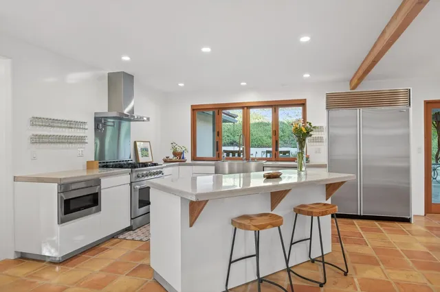 a kitchen with stainless steel appliances granite countertop a stove and a refrigerator