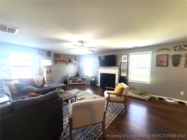 a living room with furniture and a fireplace