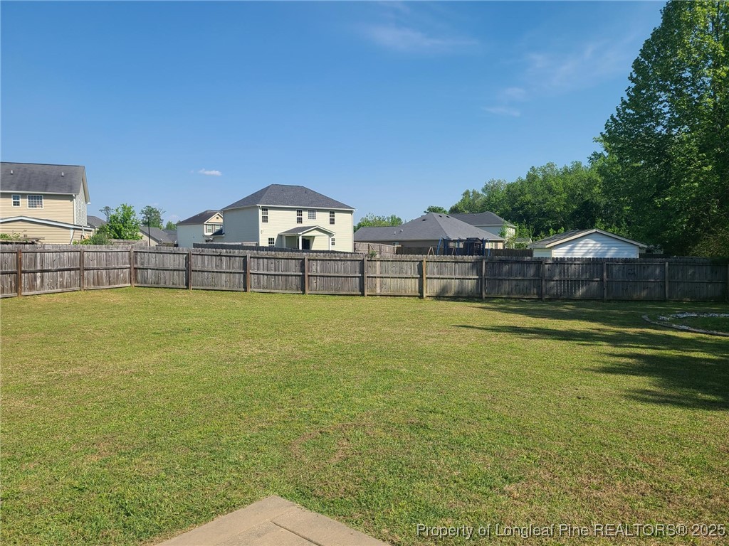 139 Spillburg Court Raeford, NC 28376 - Photo 16 of 33 a view of a swimming pool with a lawn chairs under an umbrella